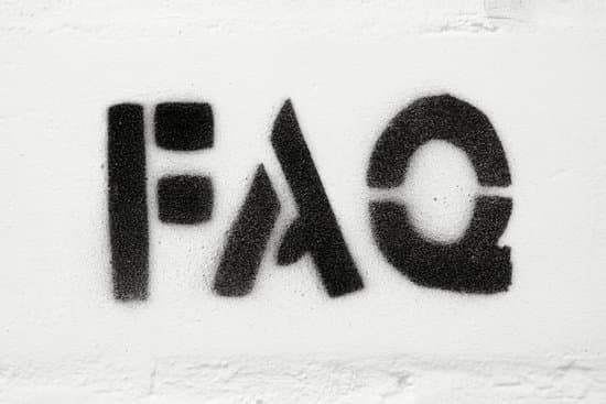 stencil print of abbreviation FAQ  on the white brick wall