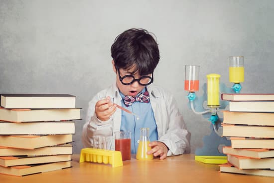 boy is making science experiments in a laboratory on gray background