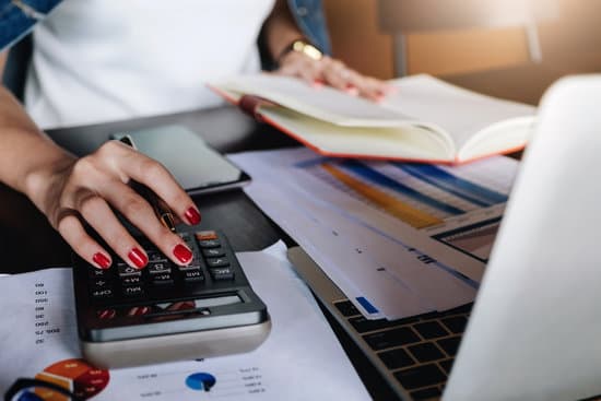 businessman working with calculator, digital tablet computer, notebook with financial business strategy layer effect in office, bookkeeper and auditor concept.