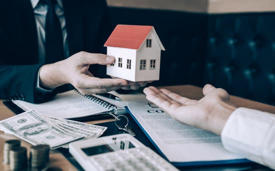 Home agents are giving house gifts to new home buyers in office room.